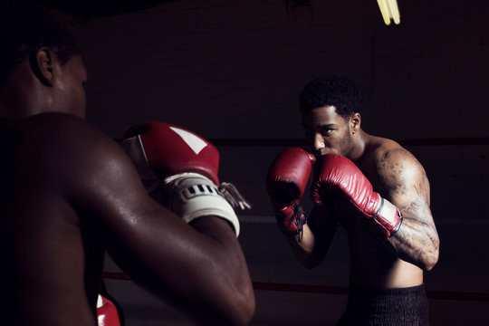 Men fighting in boxing ring
