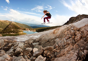 Man skateboarding on rocks against sky © Cavan for Adobe