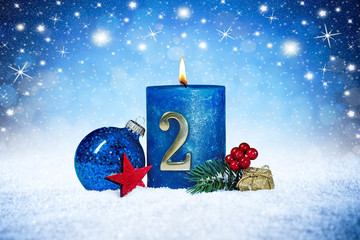 second sunday of advent blue candle with golden metal number red decoration one on wooden planks in...