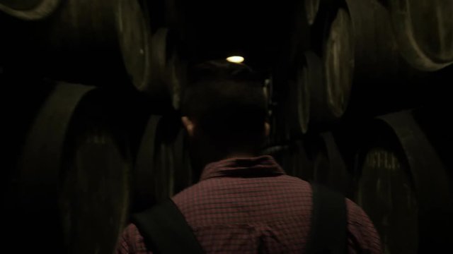 Old wine barrels in a wine cellar, sommelier man tourist dicover, porto, portugal, old factory stock