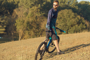 Fototapeta na wymiar Cyclist in shorts and jersey on a modern carbon hardtail bike with an air suspension fork