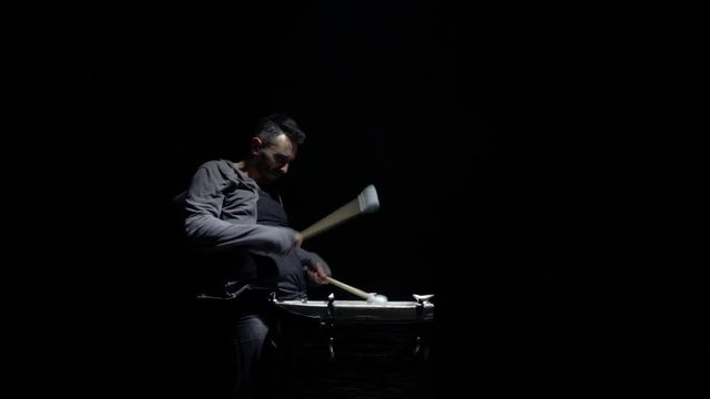 portrait of a drummer in profile on a black background