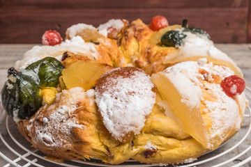 King Cake with nuts - Bolo Rei is a traditional Xmas cake with fruits raisins nut and icing on wooden table