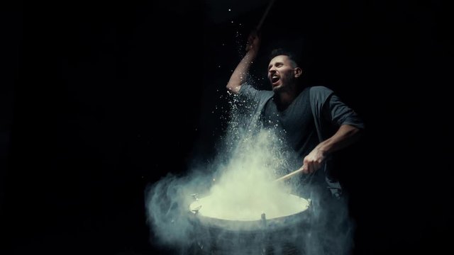 portrait of a drummer in profile on a black background