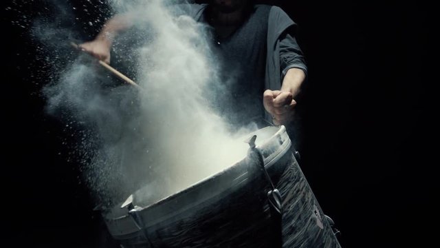 Slow motion dummer. game on a dusty drum close up
