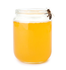 Jar with honey and bee on white background