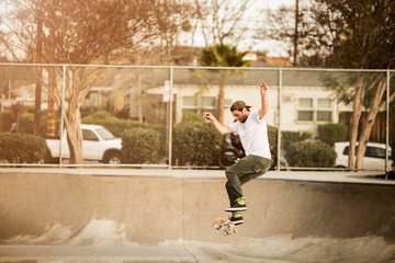 Man performing stunt at skateboard park © Cavan for Adobe