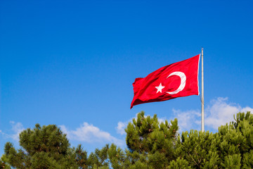 Turkish flag waving in the blue sky