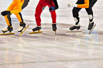 Naklejka premium Low section of skaters in skating ring