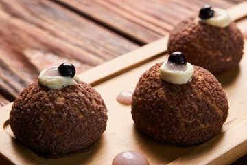 Brioche shu cake with cream chantilly, eclair. Chocolate profite