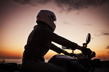Man riding motorcycle against sky during sunset © Cavan for Adobe