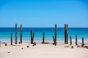 Obraz na płótnie Canvas The beautiful Port Willunga beach and iconic jetty ruins with turquoise waters on a calm sunny day on 15th November 2018