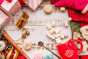 Fototapeta na wymiar Christmas decorations with a mug of marshmallows on white rustic background