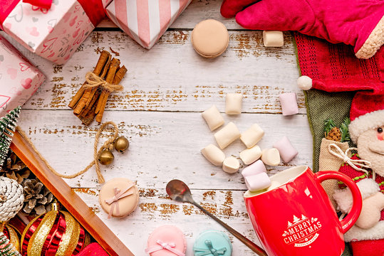 Christmas decorations with a mug of marshmallows on white rustic background