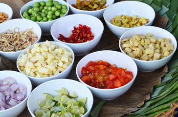 garnish spices herb in bowl / the ingredients herb for thai food with garlic chilli shallots galangal lemon grass tomato slice in white bowl