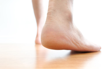 Leg of woman is on the ground. She is about to walk down the grass to exercise in the morning. Health and Relaxation Concepts