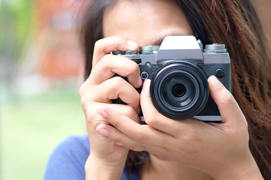 hipster lifestyle of cute girl She holds a camera. And save photos On a digital camera.Travel and Lifestyle concept