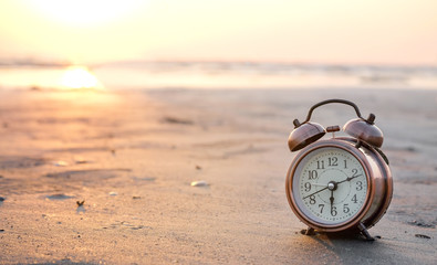 Morning of a new day, alarm clock woman playing yoga and stretching muscles on the beach sunlight...