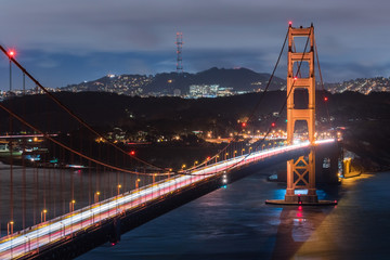 Night view of Golden Gate Bridge, Twin Peaks and the Sutro tower area in the background, San Francisco, California