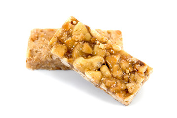 It is two closeup of caramel peanuts bar isolated on white background.Honey brittle peanuts isolated