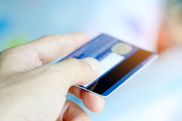 Hand of woman holds her credit card bank pay to shop for her credit card.