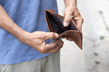 man's hand opened his wallet without money. Business, financial ideas, and expenses