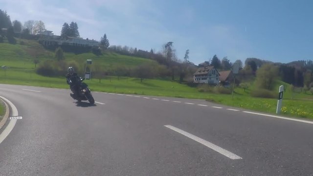 Collision between two oncoming motorcycles on a winding country road near Zurich, Switzerland