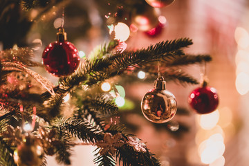 Decorated christmas tree on fireplace background