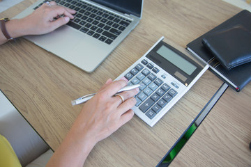 Fototapeta na wymiar Business women using calculator for calculate tax in office.investments concept