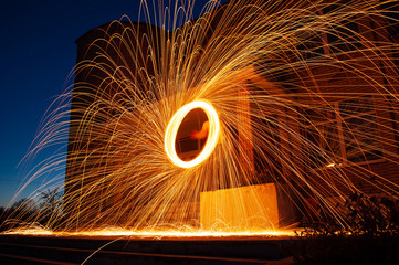 amazing fire show, spinning fire, bright sparks in the night, Steele wool photo,