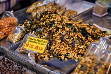 Fried peanut with chilly pepper - traditional asian street food. Asian, Indian and Chinese street food. Food court on local market of Langkawi island, Malaysia.