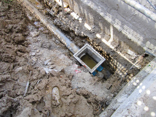 The process burying drainage pipe around the building, underground pipe in a job site.