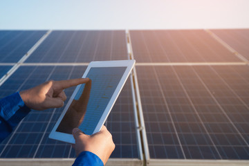 operation and maintenance in solar power plant ; engineering team working on checking and...