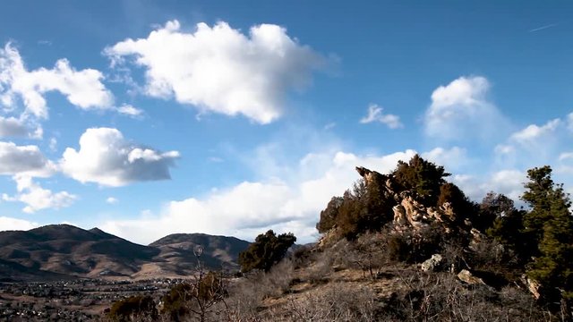 clouds moving over Dakota hogback, littleton, colorado with rocky mountains in background and scenic view of Ken Caryl valley with homes