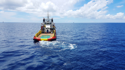 Naklejka premium Supply boat for transferring cargo to oil and gas industry . Supply boat support oil and gas industry.