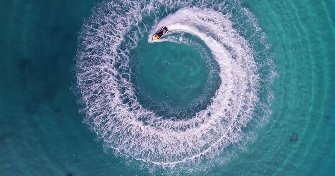 Jet skiing in circles in the Indian ocean. Powerful jet ski. Medium shot
