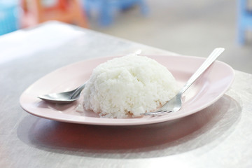 Jasmine rice with a spoon and fork on dish