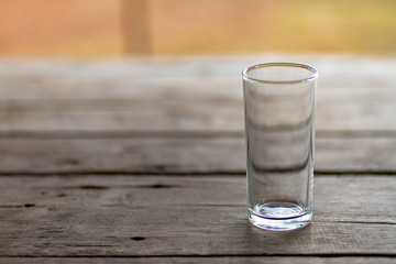glass of water empty on a wooden table in the morning