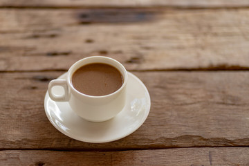 cup of coffee on a wooden table in the morning