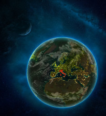Italy from space on Earth at night surrounded by space with Moon and Milky Way. Detailed planet with city lights and clouds.