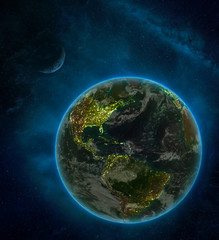 Caribbean from space on Earth at night surrounded by space with Moon and Milky Way. Detailed planet with city lights and clouds.