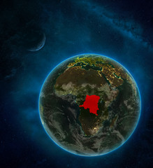 Dem Rep of Congo from space on Earth at night surrounded by space with Moon and Milky Way. Detailed planet with city lights and clouds.