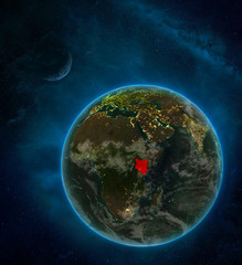 Kenya from space on Earth at night surrounded by space with Moon and Milky Way. Detailed planet with city lights and clouds.
