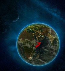 Somalia from space on Earth at night surrounded by space with Moon and Milky Way. Detailed planet with city lights and clouds.