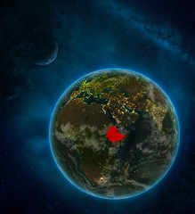Ethiopia from space on Earth at night surrounded by space with Moon and Milky Way. Detailed planet with city lights and clouds.