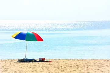 colorful beach umbrella with a cushion and small pillow on deserted beach in a sunny day, Phuket, Thailand