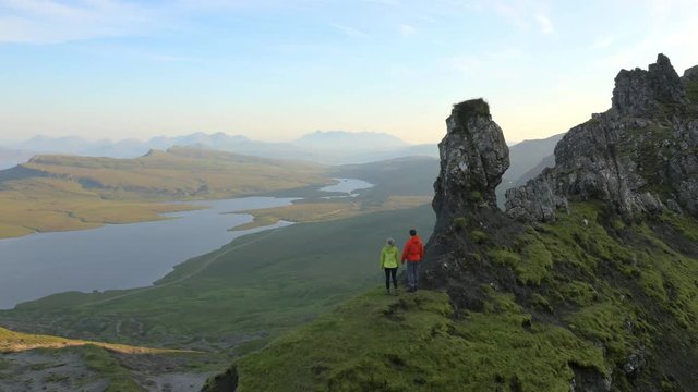 Aerial view of couple hill walking Trotternish Ridge Skye Scotland