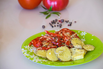 Baked potatoes and vegetables with spices. Stewed potatoes with tomatoes, sweet red pepper and spices.