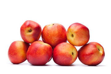 group of juicy peaches lying isolated on a white background