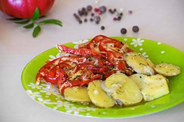 Baked potatoes and vegetables with spices. Stewed potatoes with tomatoes, sweet red pepper and spices.
